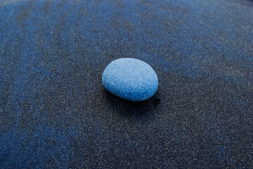 Fototapeta na wymiar The round stone on Black sand beach