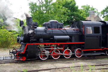 Old steam locomotive move on the rail