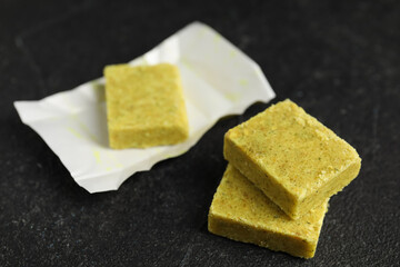 Aromatic natural bouillon cubes on black table, closeup