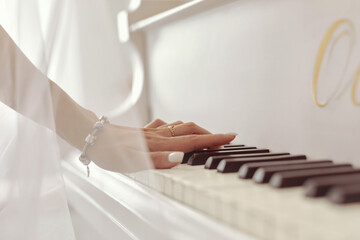 A woman playing the piano. A woman's hand close-up