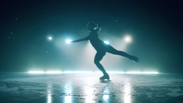Female figure skater is jumping during skating