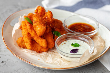 Deep fried shrimps served with sauce on plate