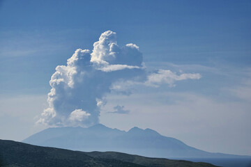 huge white clouds over the mountains and sea with volcanic mountain view 