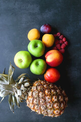 Various colorful fruit on dark background. Flat lay.