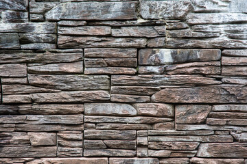 brown horizontal wall made of decorative stone
