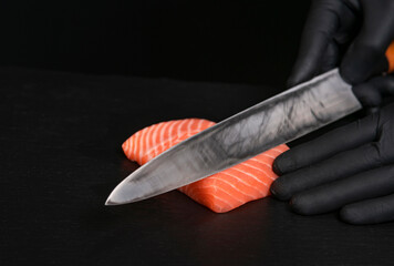 Japanese chef making sashimi on black desk