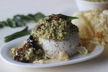 Steamed rice cake served with green gram curry and papad. A favorite dish of Kerala commonly known as puttu with payar and pappadam.