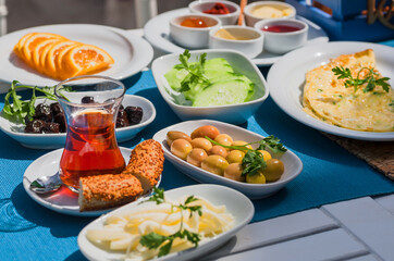 Dinner time with olives, vegetables, fruits, bread and black tea cup in oriental style. Healthy...