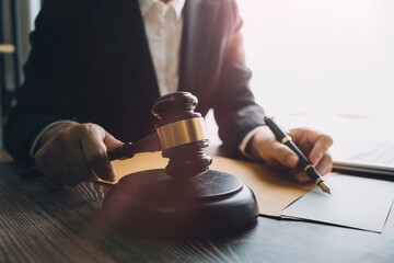 Business and lawyers discussing contract papers with brass scale on desk in office. Law, legal...