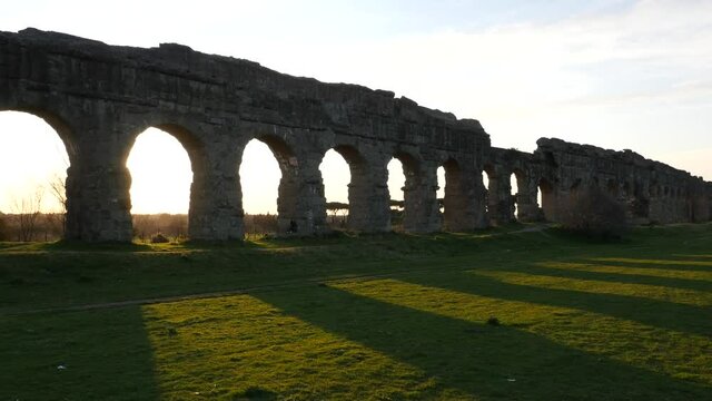 Aerial drone footage view of ANCIENT ROMAN AQUEDUCT - ROME - ITALY A spectacular building of the Roman Empire at sunset // no video editing
