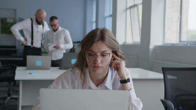 Girl carefully reads something on the computer, stuff