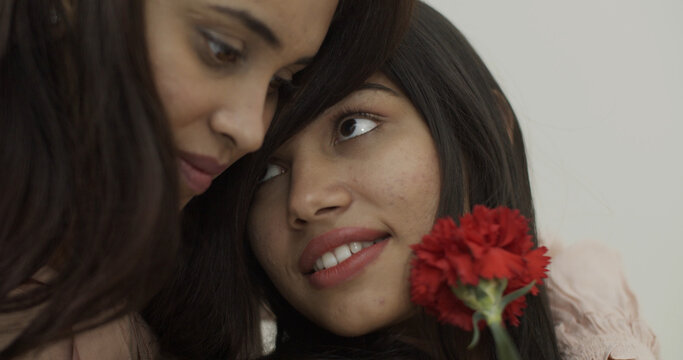 Cute Lesbian Indian Couple With A Red Flower Isolated On A White Background