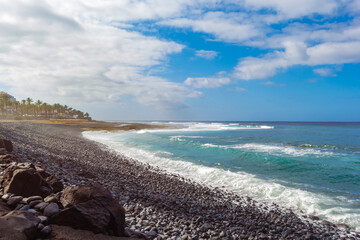 Empty sea pebble beach and beautiful waves. Santa Cruz de Tenerife, Spain’s Canary Island