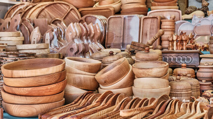 Handmade wooden souvenirs for tourists. Beautiful kitchen utensils: bowls, plates, spoons, cutting boards.