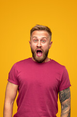 Thrilled hipster man looking at camera and screaming