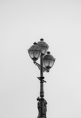 old style street lamp on a wall in black and white 