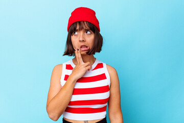 Young mixed race woman isolated on blue background having a strong teeth pain, molar ache.