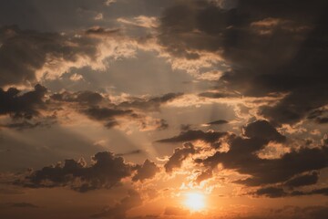 Natural background: sun and clouds are reflected in the water at sunset in summer