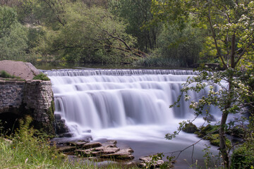 Long exposure photography of Monsal Weir - waterfall at Monsal Dale in the Peak District, Derbyshire