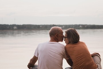 Fototapeta premium Senior couple kissing on beach in summer evening