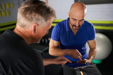 Gordijnen Male personal trainer , physical health consultation with elderly man © JonoErasmus