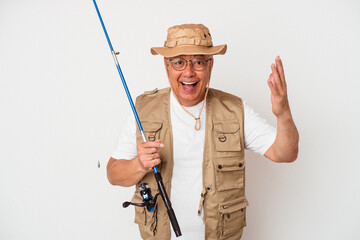 Senior american fisherman holding rod isolated on white background receiving a pleasant surprise, excited and raising hands.