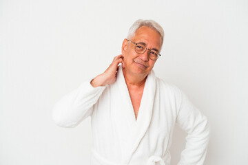 Senior american man wearing bathrobe isolated on white background touching back of head, thinking and making a choice.