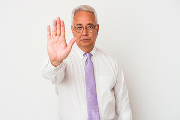 Senior american man isolated on white background standing with outstretched hand showing stop sign, preventing you.