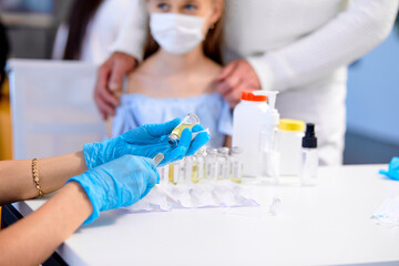 nurse is preparing to give injection vaccine against covid-19, close-up. Mass vaccination of...
