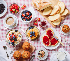 BIG BREAKFAST with blueberry pancake, bread, coffee, muffin, yoghurt, fruits ON A RED SQUATE TABLECLOTH