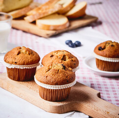 blueberry muffins ON A RED SQUATE TABLECLOTH