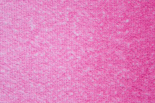 Terry towels of dark red, burgundy color. Textured surface. The color changes saturation with a gradient. The image can be used as texture or background. Copy space.