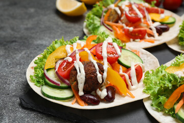 Delicious vegetarian tacos served on grey table