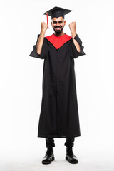happy smiling indian male graduate student in mortar board and bachelor gown with diploma celebrating success over grey background