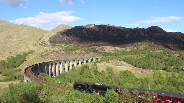 4k footage of the Jacobite Steam Train crossing the Glenfinnan Viaduct near Fort William in the Scottish Highlands, UK