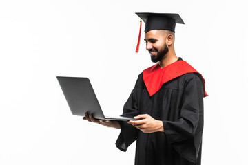 Male graduate holding a laptop and smiling at the camera isolated on white background