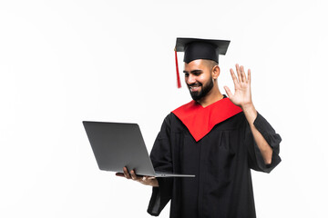 Male graduate holding a laptop and smiling at the camera isolated on white background