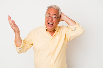Senior american man isolated on white background screaming with rage.