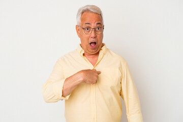 Senior american man isolated on white background surprised pointing with finger, smiling broadly.