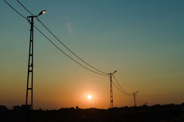 Fototapeta na wymiar power lines in sunset