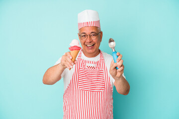 Senior american ice cream maker holding an ice cream isolated on blue background