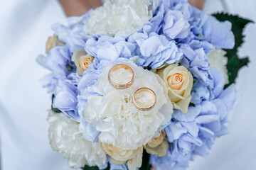 Wedding rings on a bouquet of roses