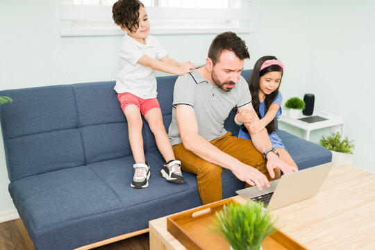 Son And Daughter Asking Their Dad To Play