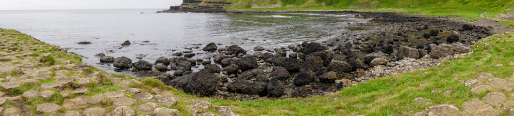 Giant's Causeway basalt rocks pattern in a beautiful summer day, Northern Ireland. The nature hexagon stones result of an ancient volcanic fissure eruption.