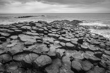 Giant's Causeway basalt rocks pattern in a beautiful summer day, Northern Ireland. The nature hexagon stones result of an ancient volcanic fissure eruption.