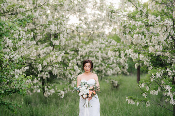 bride in a white dress with a large spring bouquet