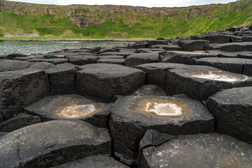 Giant's Causeway basalt rocks pattern in a beautiful summer day, Northern Ireland. The nature hexagon stones result of an ancient volcanic fissure eruption.