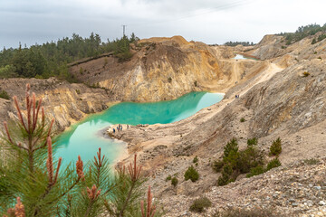 Amazing landscape of yellow sand and turquoise lakes in a tungsten mine. Beautiful wild panorama....