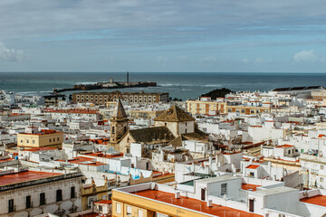 Cadiz, Andalusia, Spain. Aerial panoramic view from Tavira tower of old city with narrow winding alleys, rooftops and seashore on sunny day.European cityscape.Beautiful white city on Atlantic coast.