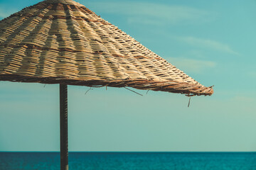 beach umbrellas and sun loungers on empty beach